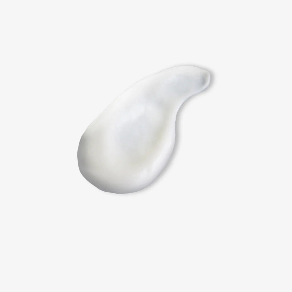 White cream smear on a light gray background