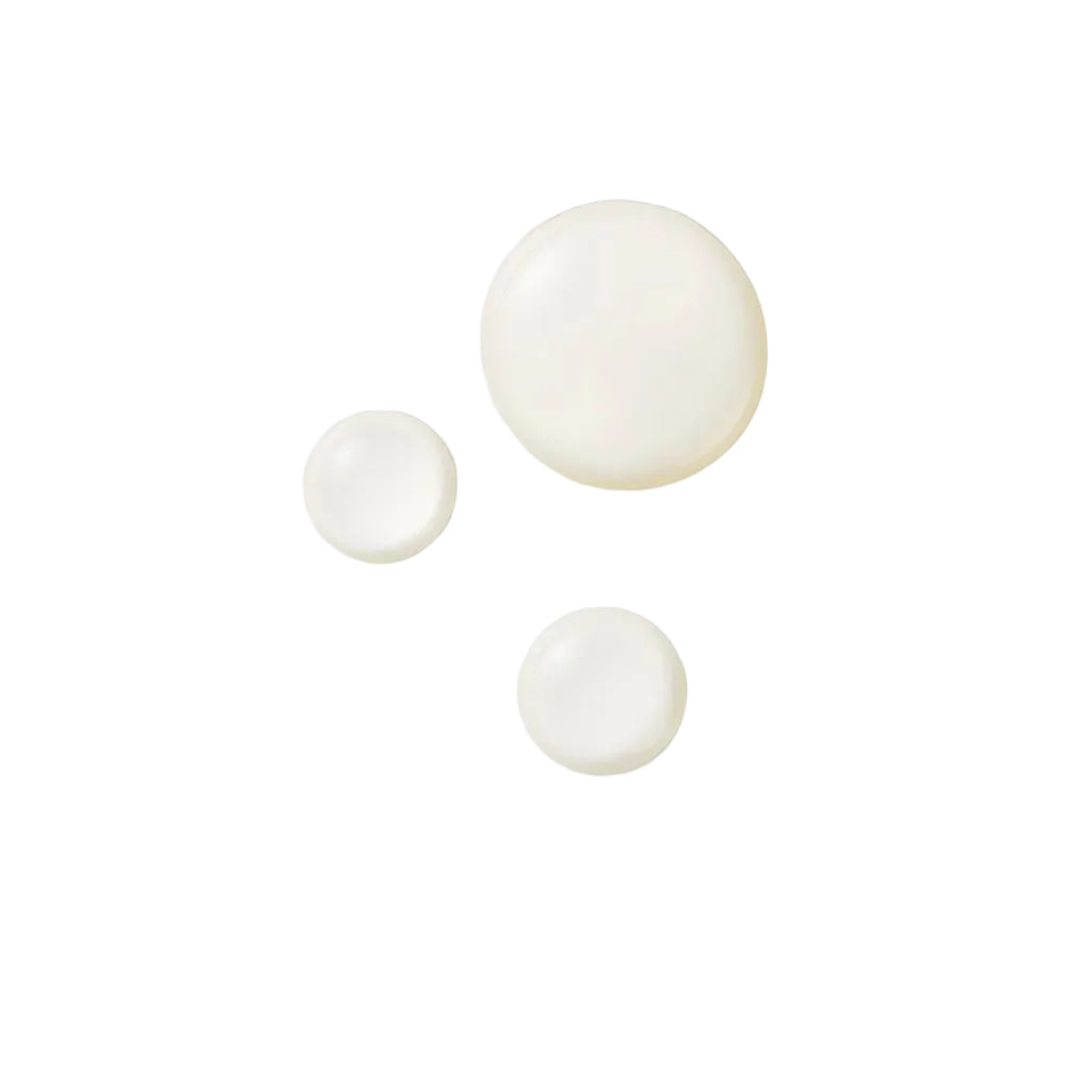 Three white circular objects on a light beige background