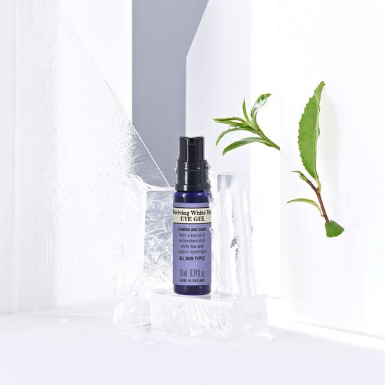 Reviving White Tea Toning Eye Gel package with leaves on ice platform